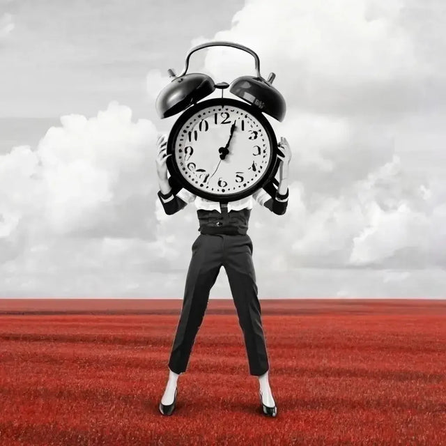 Man Practicing Time Management Holding Alarm Clock In Field To Reduce Stress.